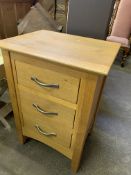 Laminated oak chest of three drawers.