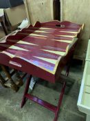 Decorative burgundy coloured Butler's tray decorated in the style of a backgammon board, on stand