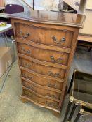 Yew wood bow fronted chest of six drawers with brass handles.