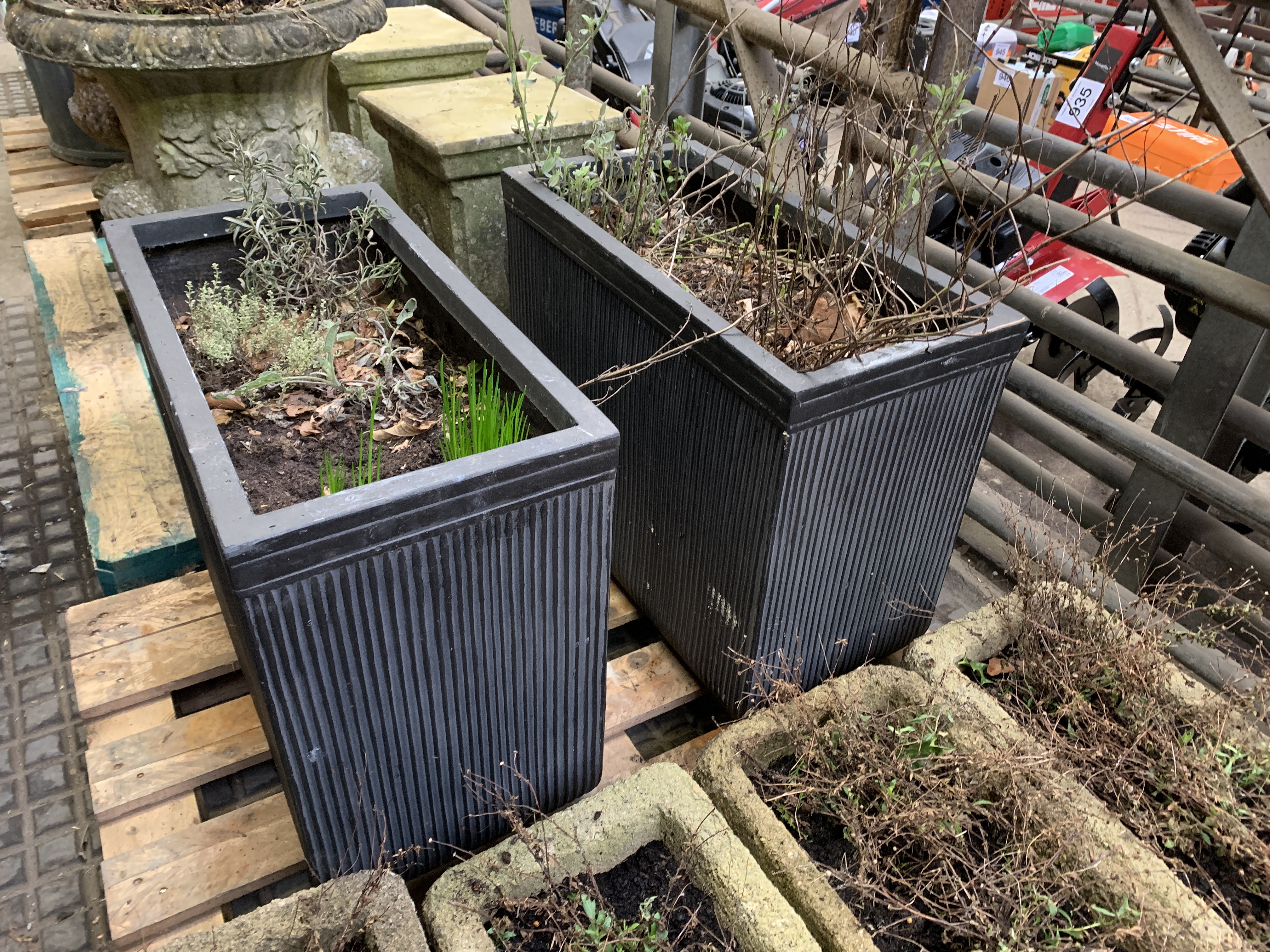 Two filled large ceramic style rectangular planters.