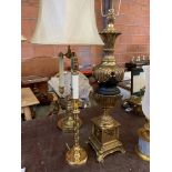 Brass and black ceramic urn shaped table lamp on brass base with another lamp.