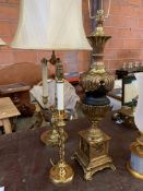 Brass and black ceramic urn shaped table lamp on brass base with another lamp.