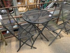 Grey metal mesh circular table with two folding chairs