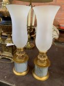 Pair of brass and marble candle holders with tall frosted glass storm shades.