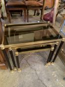 A graduated group of three gilt metal and ebonised occasional tables, with a similar side table.