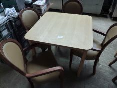 Wooden table with four upholstered chairs