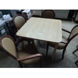 Wooden table with four upholstered chairs