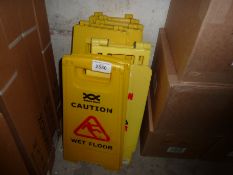 Seven wet floor caution signs.