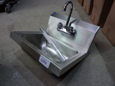 Stainless steel hand sink with tap.