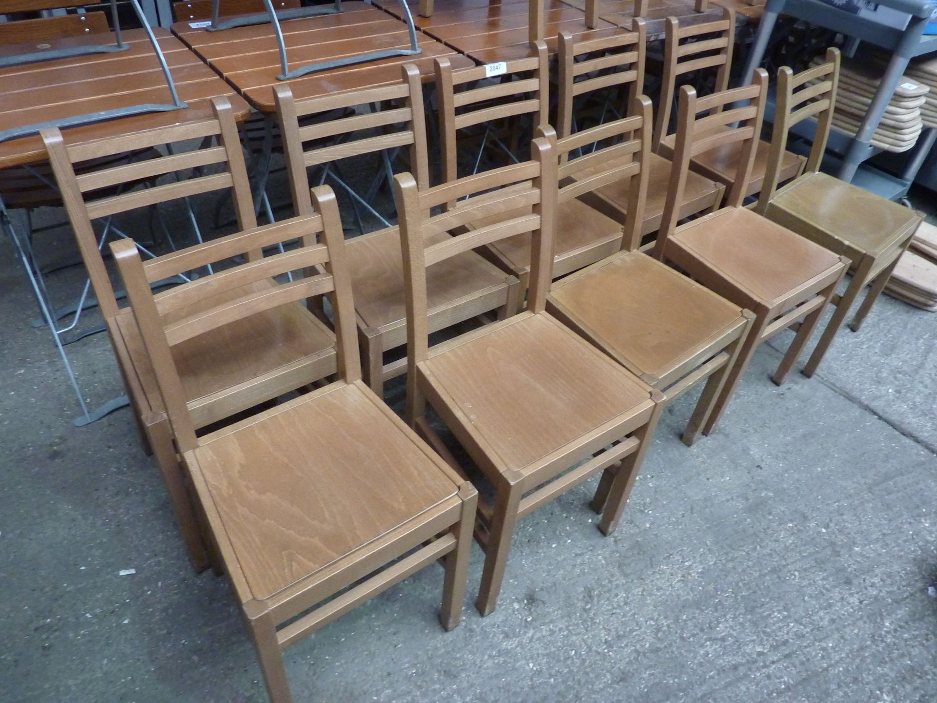 Ten wooden chairs.