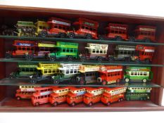 Wooden display case containing 25 assorted Buses