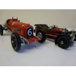 Single seater Ferrari racing car and a burgundy 3-wheel racing car