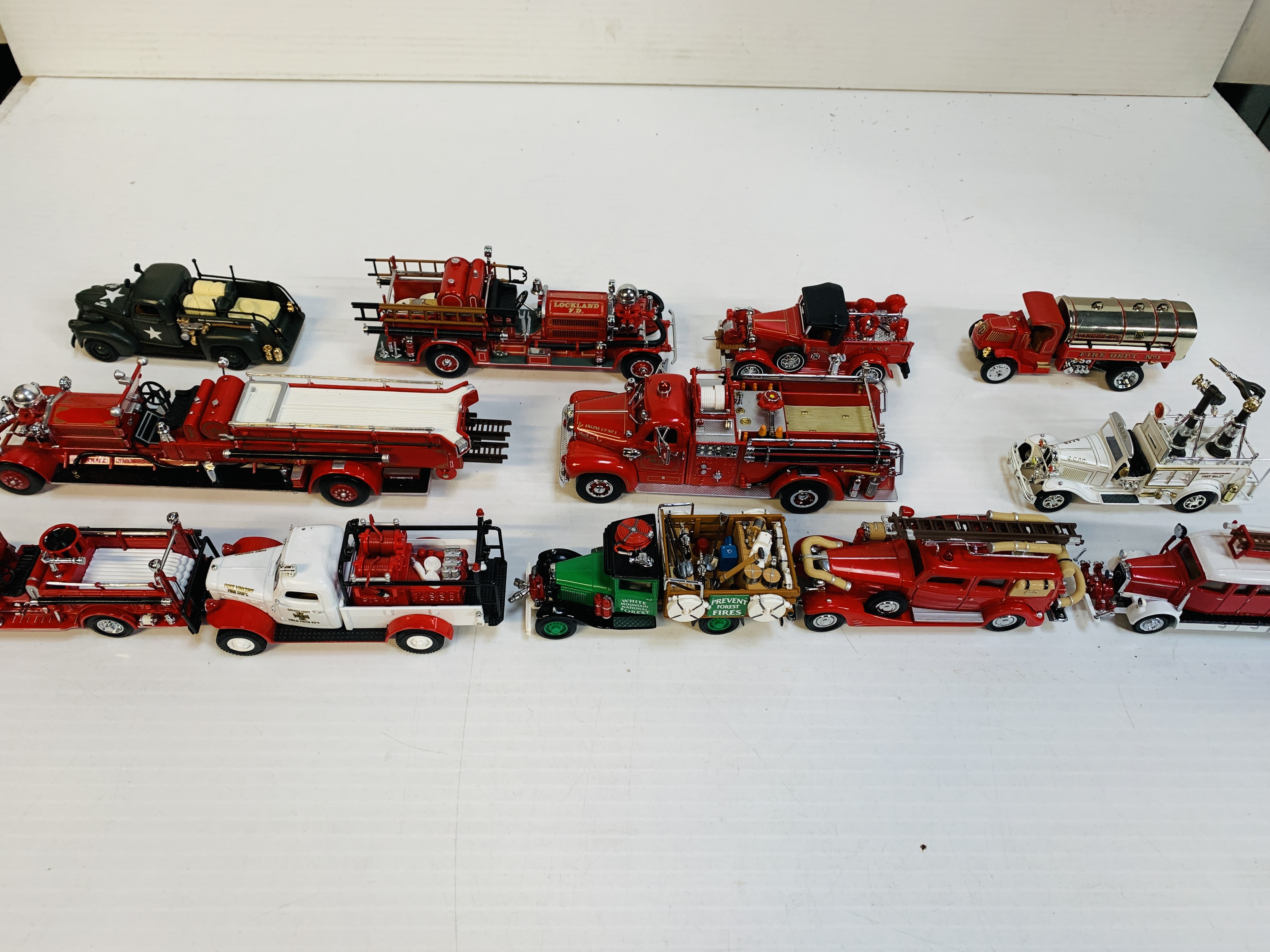 Twelve assorted fire fighting vehicles.