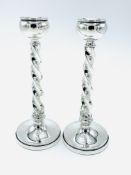 A pair of silver candlesticks with barley twist stems