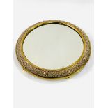 Circular gilt metal mirrored stand on five bun feet.