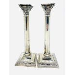 A pair of sterling silver candlesticks of Corinithian column design hallmarked London 1944