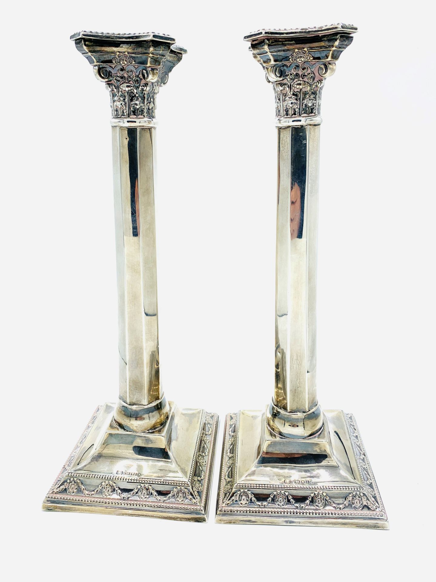 A pair of sterling silver candlesticks of Corinithian column design hallmarked London 1944