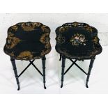 Two black lacquered trays on black painted 4-legged stands,