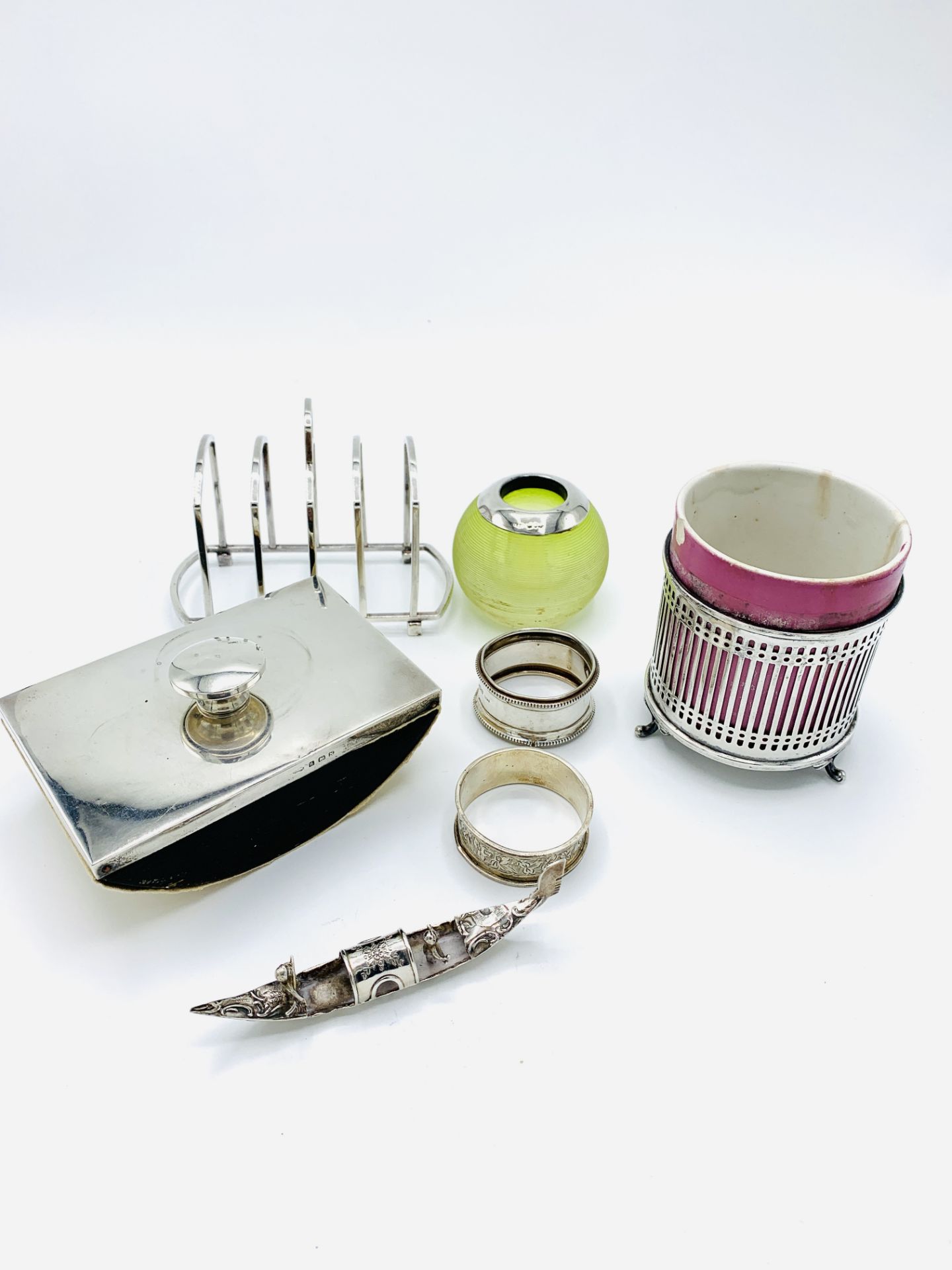 Silver mounted glass match striker, rail sided pot holder; ink blotter; 2 napkin rings; toast rack