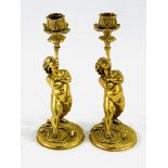 Two solid brass cherub candlesticks