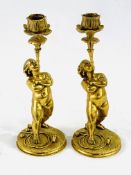 Two solid brass cherub candlesticks