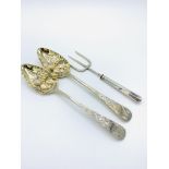 Two George III silver and gilt berry spoons and a silver 3 prong fork
