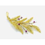18ct gold brooch set with diamonds and rubies in the form of a sprig of leaves