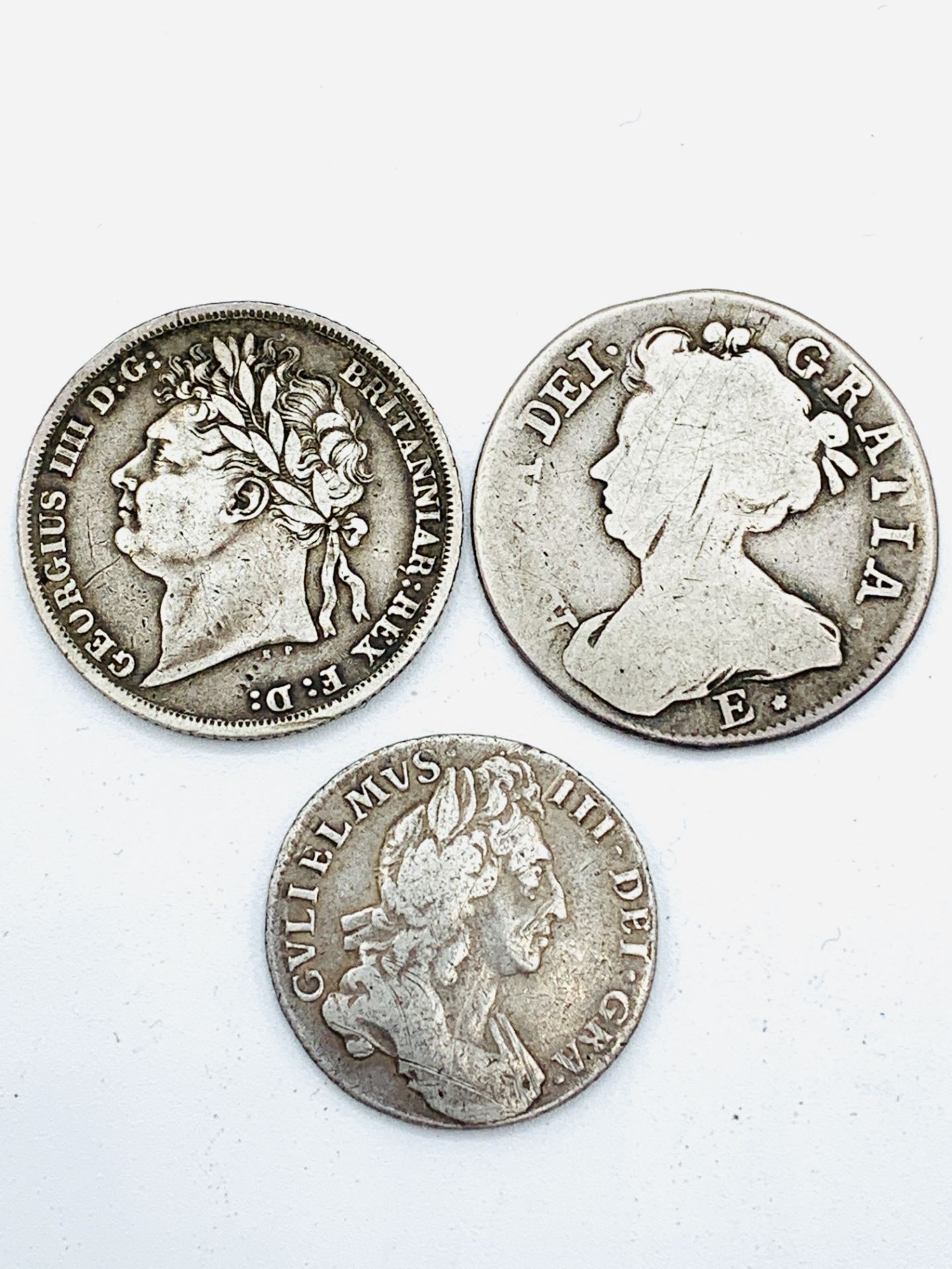 A Queen Anne sixpence 1708, a George IV shilling 1824 and a William III shilling