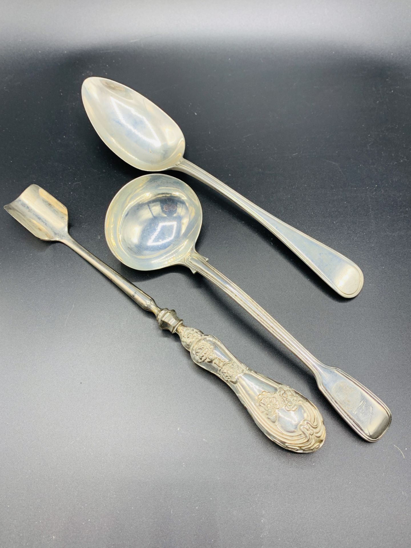 Victorian silver table spoon, a Victorian silver ladle, and a silver handled stilton cheese scoop.