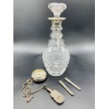 Cut glass decanter with hallmarked silver rim, and various silver items