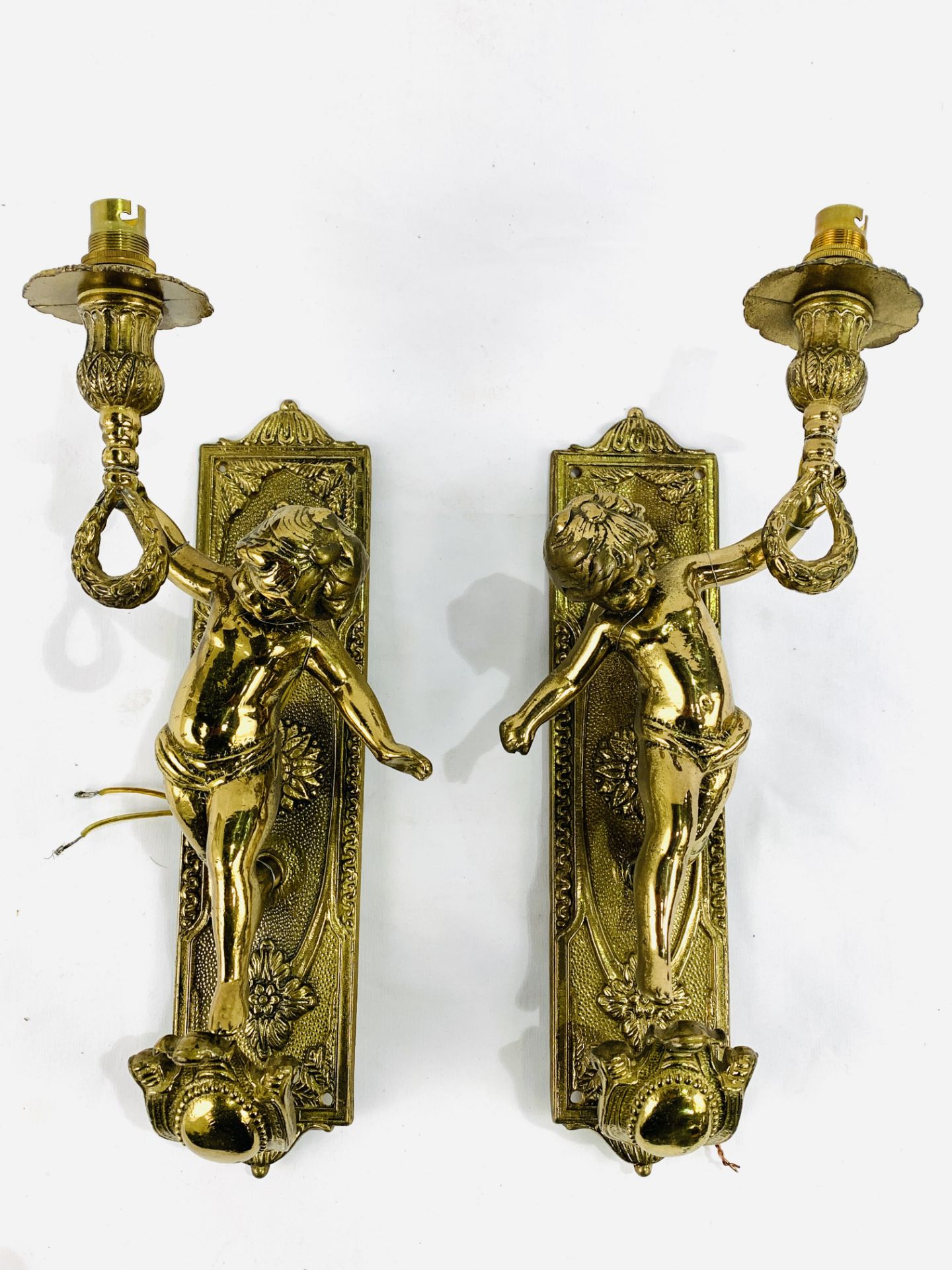 Pair of solid brass electric cherubic wall sconces complete with wooden mounts