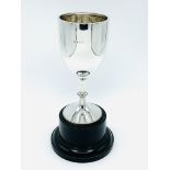 Silver goblet on black trophy stand