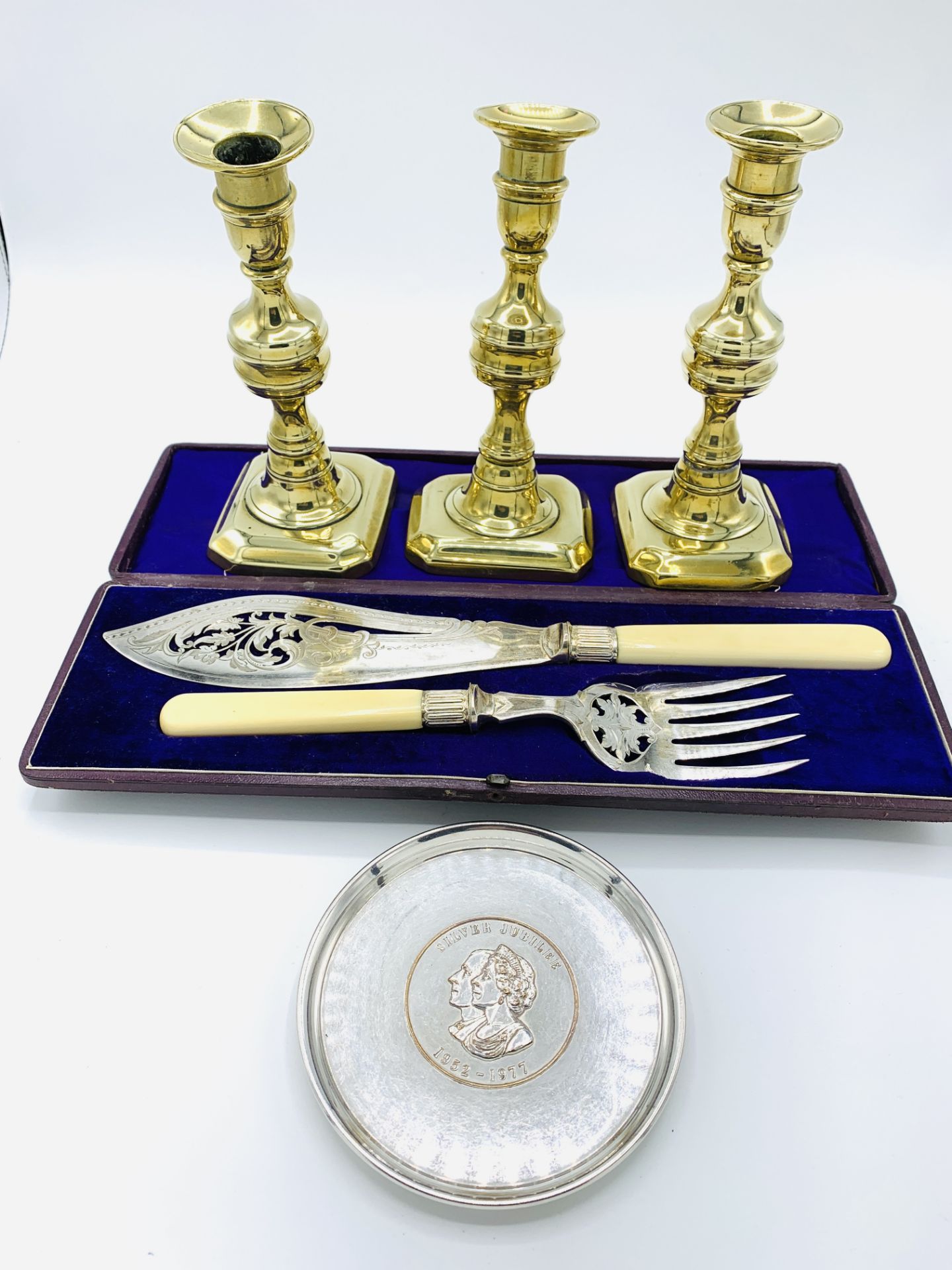 3 Georgian brass candlesticks, silver plated fish servers, and a silver plated Silver Jubilee salver