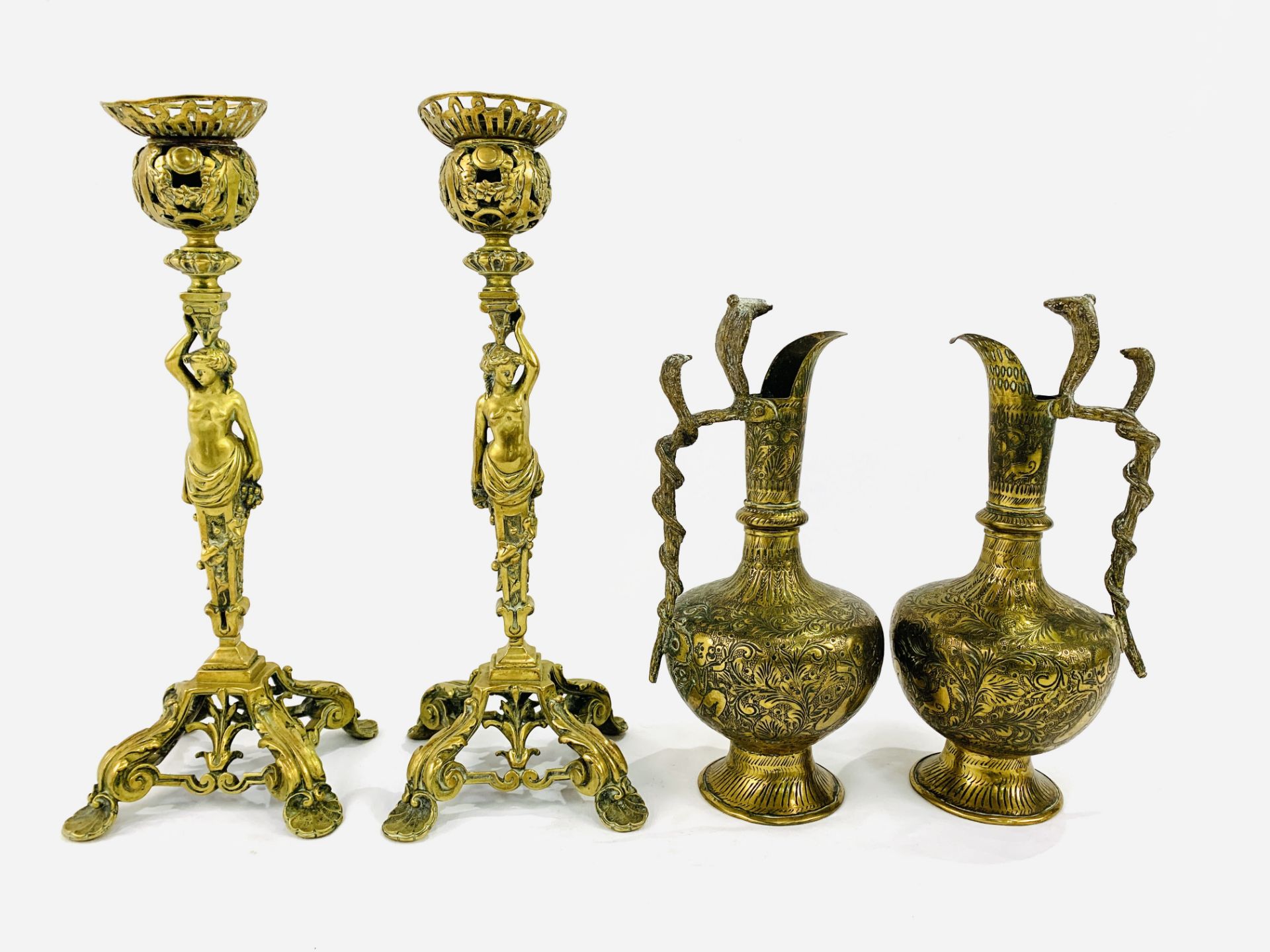 Pair of brass figural candlesticks with two Indian brass ewers