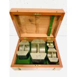 A boxed set of Avoir brass standard weights: 50lbs, 20lbs, 10lbs and 5lbs by De Grave, London.