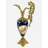 Large 19th century continental gilt metal porcelain ewer with picture cartouche and gilded relief