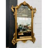 Regency style gilt framed wall mirror with applied carvings