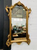 Regency style gilt framed wall mirror with applied carvings