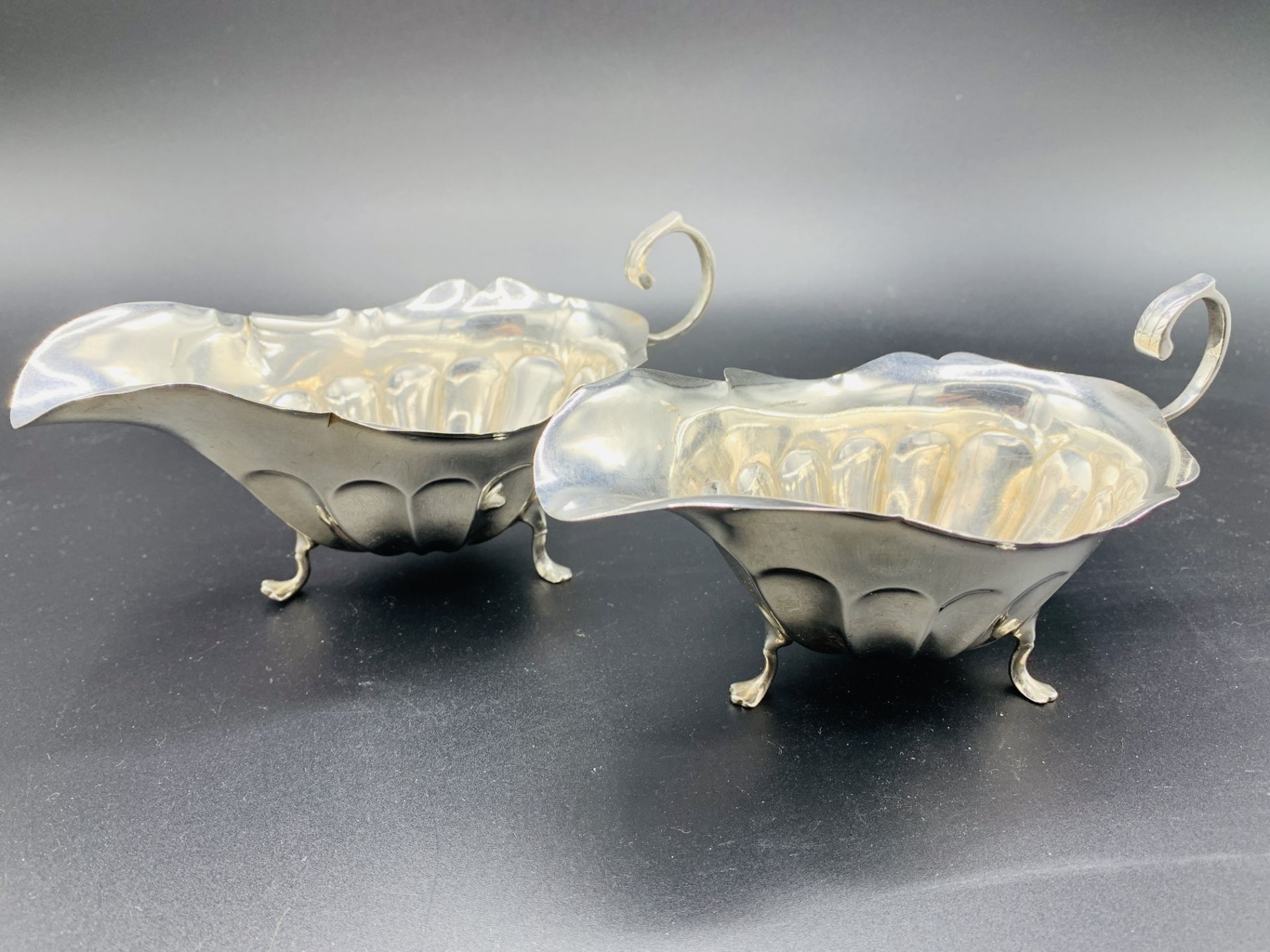 A pair of silver sauce boats hallmarked Sheffield 1919 by James Deakin & Sons
