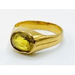 A 22k gold ring set with a yellow sapphire