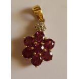 Pink stone and diamond floral pendant on 9ct gold.