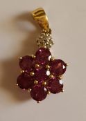 Pink stone and diamond floral pendant on 9ct gold.