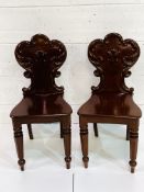 Two mahogany hall chairs with shaped backs