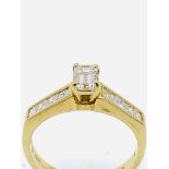 750 gold ring with baguette cut centre diamond and diamonds to shoulders