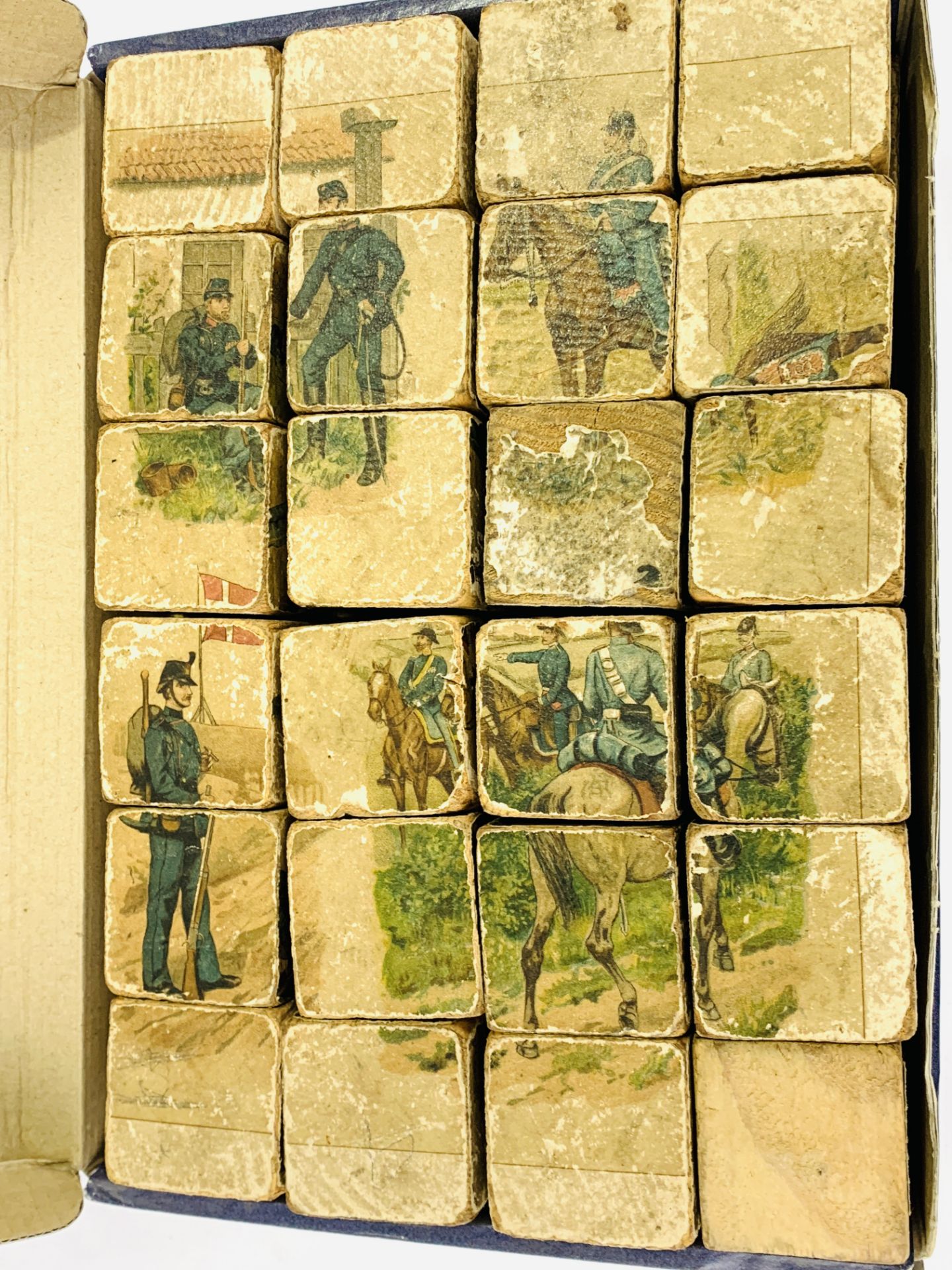 48 6-sided wooden puzzle blocks to make up 6 different pictures of 19th century European soldiers.