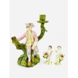 Royal Worcester porcelain figural candlestick, and two porcelain cherub figurines,
