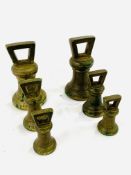 Two sets of brass Imperial standard bell weights