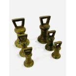 Two sets of brass Imperial standard bell weights