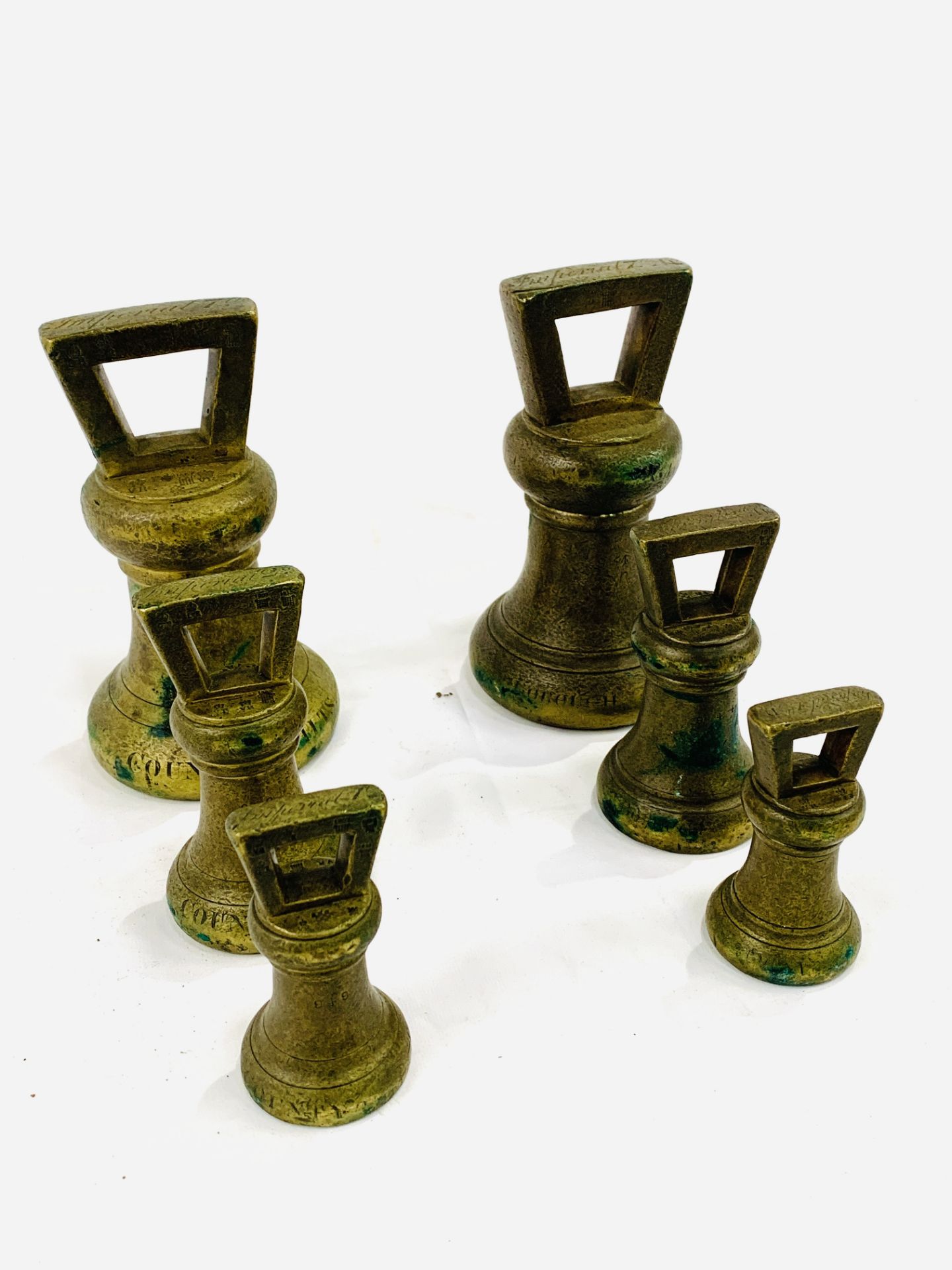 Two sets of brass Imperial standard bell weights