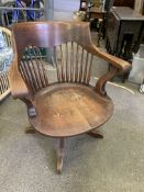 1930's oak swivel, height adjustable and reclining spindle back armchair